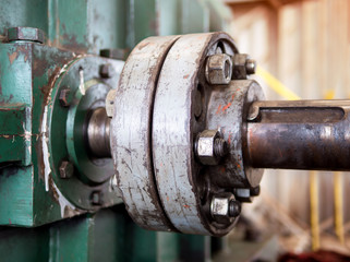 Old hydraulic motor connection point in factory. Close up of nut on the rotor induction and the shaft of the motor pump. Industrial production lines concepts. - Selective focus