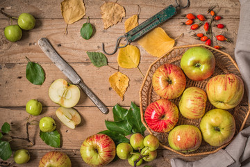 Composition with fresh apples on old wooden table