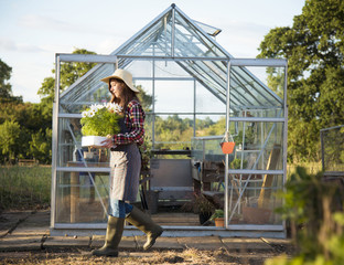 Young woman in the glass greenhouse