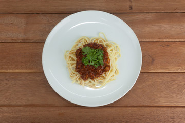 Pasta, macaroni and tomato sauce on a white dish are delicious. Put on a old wooden table.top view