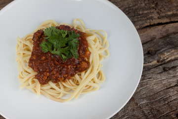 Pasta, macaroni and tomato sauce on a white dish are delicious. Put on a old wooden table.close up