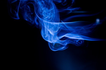 Fototapeta premium Blue toxic fumes movement on a black background.