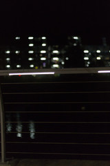 abstract pedestrian bridge at night in south german city near stuttgart with bokeh led lights in the dark background