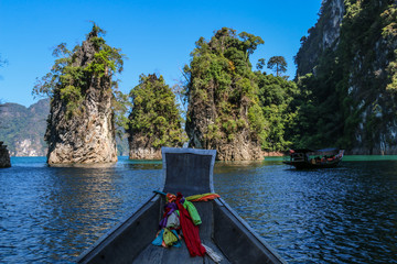 Sightseeing  toursit boat with Three bars stand together in sea (Guilin of Thailand) at Cheow lan lake,Ratchaprapha dam,Suratthani,Thailand.(KHAO SOK National Park )
