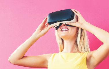 Happy young woman using a virtual reality headset