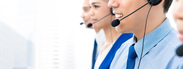 Call center agents talking on the phone to customers with a friendly and helpful attitude