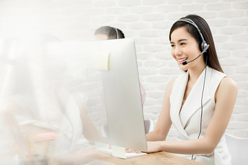 Beautiful Asian woman telemarketing customer service agent working in call center
