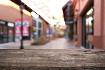 Empty dark wooden table in front of abstract blurred background of coffee shop . can be used for display or montage your products.Mock up for display of product