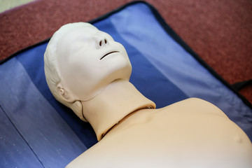 CPR training medical procedure - Demonstrating chest compressions on CPR doll