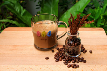 Coffee Latte with beans on wooden plate