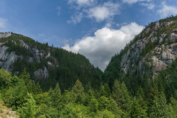 High mountain landscape with blue cloudy sky.