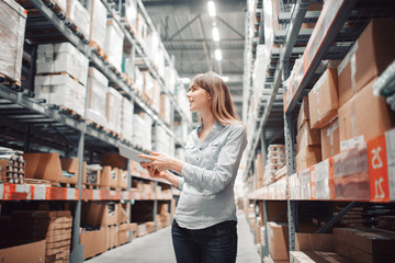 stock taking. beautiful young woman worker of furniture store.