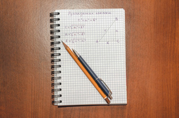 Page with formulas and the Pythagorean theorem with pen and pencil