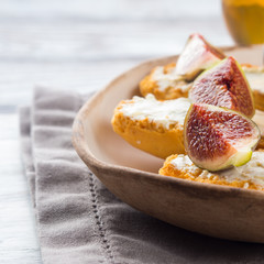 Crostini with cheese and figs. Light sweet and savory snack with wine