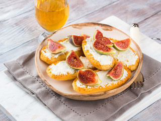 Crostini with cheese and figs. Light sweet and savory snack with wine