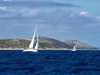 Sailing yacht in Croaatia, windy summer on the boat between rocky islands of the Mediterranean sea