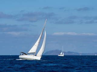 Naklejka premium Sailing yacht in Croaatia, windy summer on the boat between rocky islands of the Mediterranean sea