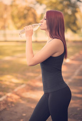 Woman drink water in the park