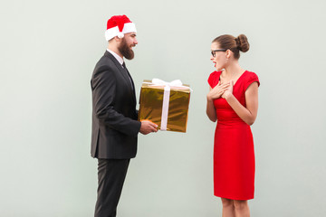 Bearded man in red cup give a present beautiful woman