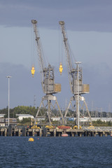 Fototapeta premium Two Dockside Cranes in Southampton against a blue sky