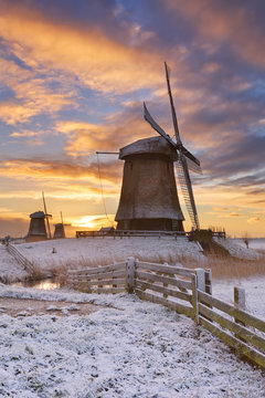 Traditional Dutch windmills in winter at sunrise