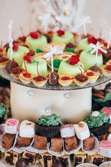 Variety of sweet desserts with fruits and alcohol drinks on the wedding banquet.