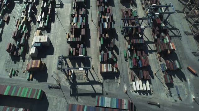 Aerial birds eye view of stacked containers at a trading port.