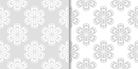 Fototapeta na wymiar Light gray floral backgrounds. Set of seamless patterns for textile and wallpapers