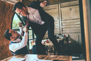 Businessman fighting with his coworker in office.