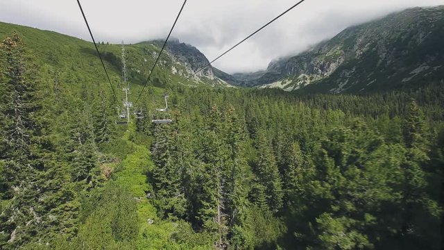 Ski-lift cable car leading to Predne Solisko peak of Tatra mountains, Slovakia. Beautiful summer landscape with mountain range and green forest. Sport lifestyle, holidays, travel, recreation. Full HD