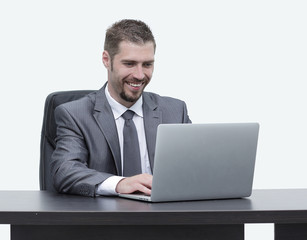 closeup.happy businessman working on laptop, sitting at desk