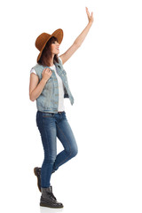 Smiling Young Woman In Brown Suede Hat Is Waving Hand