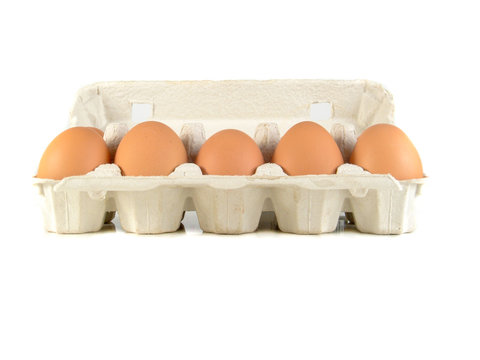 Close up of brown eggs in a egg tray. Chicken eggs. Fresh eggs on a white background