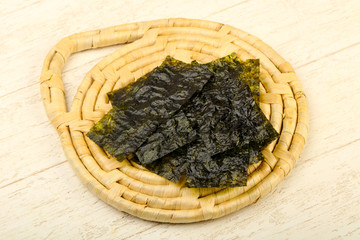 Nori sheets over wooden background