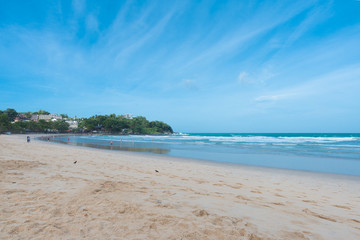 Beach and sea. Tropical beach and clear blue sky  early in the morning with some tourists and resort in background,holiday concept. 
