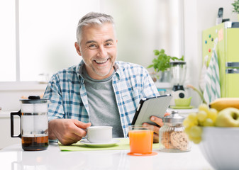 Man having breakfast and social networking