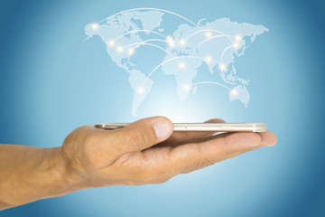 hand with smartphone and hologram of world network