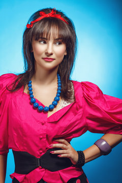Young woman wearing colorful old-fashion clothes in pinup style