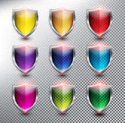 Collection of 9 blank protection shields. Shield icons in 9 different colors. Transparent and isolated with realistic shine and shadow on the light background. Vector illustration. Eps10.