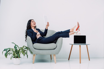 laughing businesswoman using tablet