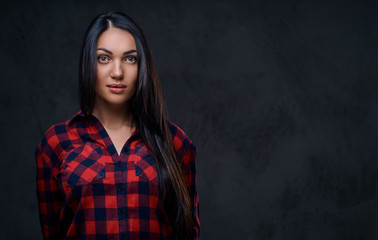 A woman dressed in a red fleece shirt over grey background.