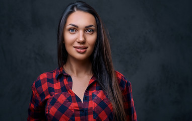 A woman dressed in a red fleece shirt over grey background.