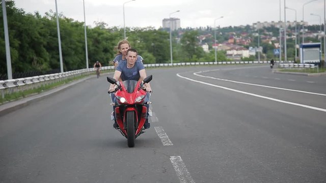 Man and woman on a motorcycle outdoors. young beautiful couple on a motorcycle in the city.