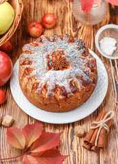 Apple pie with cinnamon, cardamom, anise, powdered sugar. Homemade delicious cakes for tea. Rustic style, selective focus