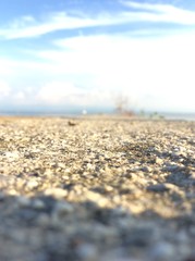 Sea coast closeup and blue sky with pebbles
