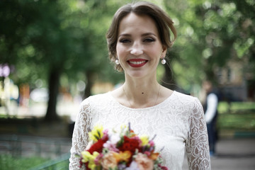 Bride with a bouquet of flowers in a white dress at a wedding