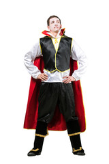 halloween, clothes, holidays concept. strong figure of man isolated on the white background, he is wearing like count dracula and has scary make up, white face with red leaks of blood