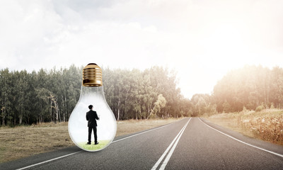 Businessman inside light bulb