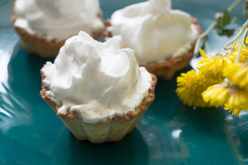 Several cakes basket with whipped cream.