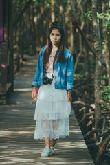 women Asian hipster take a photo in deep forest in Thailand. Travel Concept.